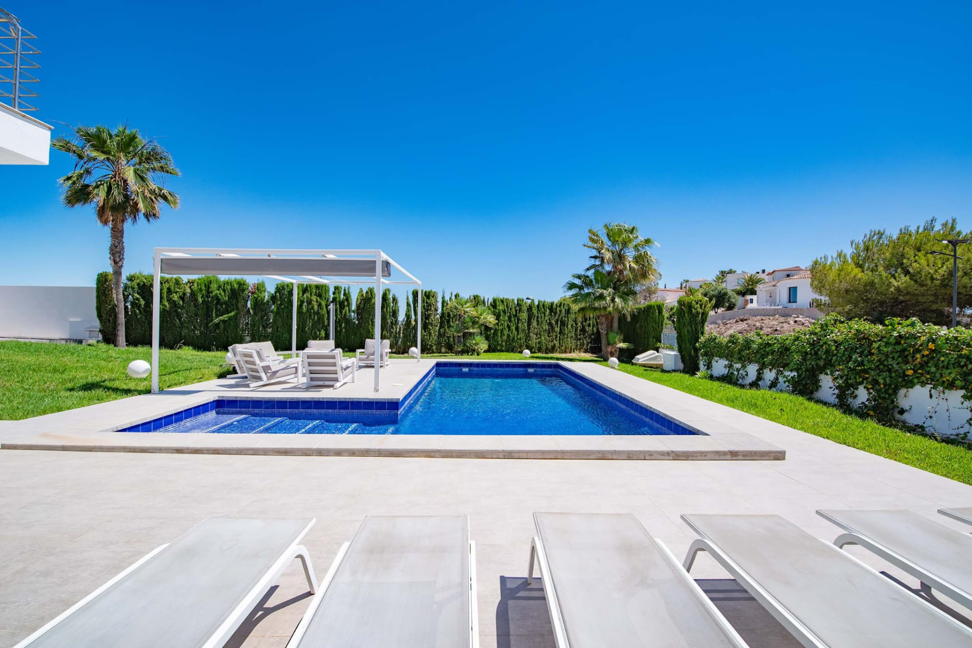 Pool mit Sonnenliegen und Lounge im Garten
